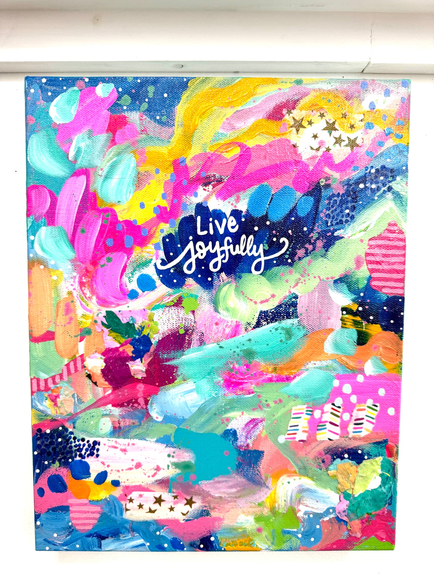 Colorful abstract design with 'Live joyfully' text on a white background